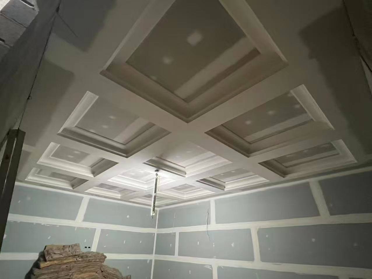 Coffered plasterboard ceiling with layered recesses, ready for paint